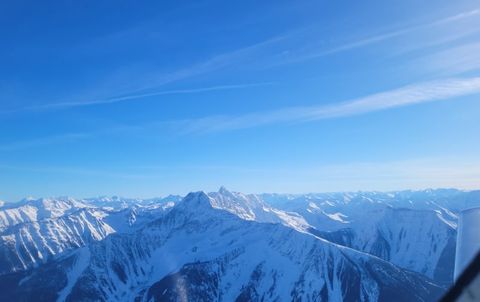 Snow-covered Rocky Mountain peaks under a clear blue sky